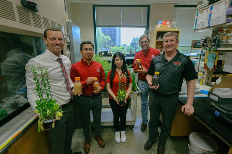 Group photo of researchers holding pennycress