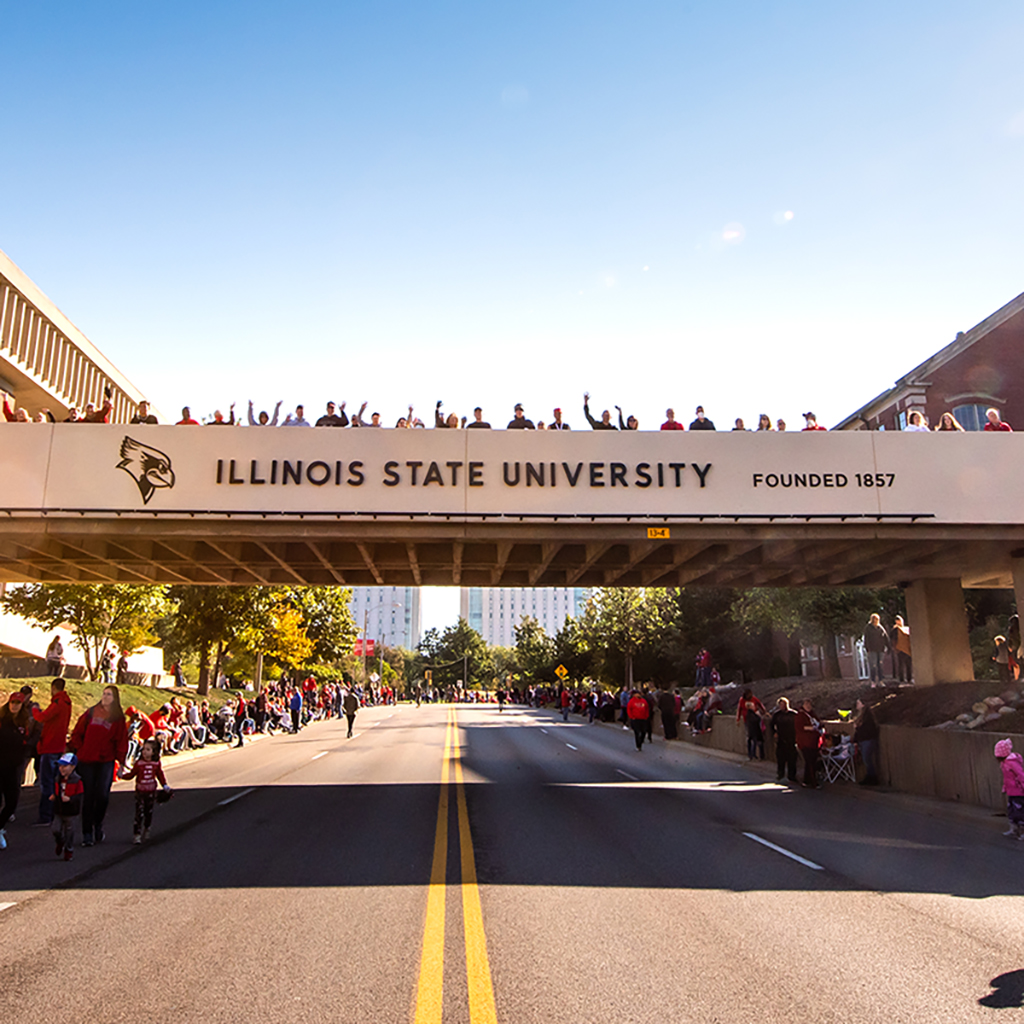 A banner reading 'Welcome Home, Alumni' hangs on the Alumni Center.